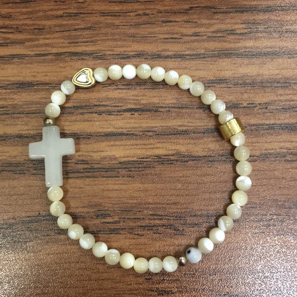 Jewelry - White cross bracelet with gold detail